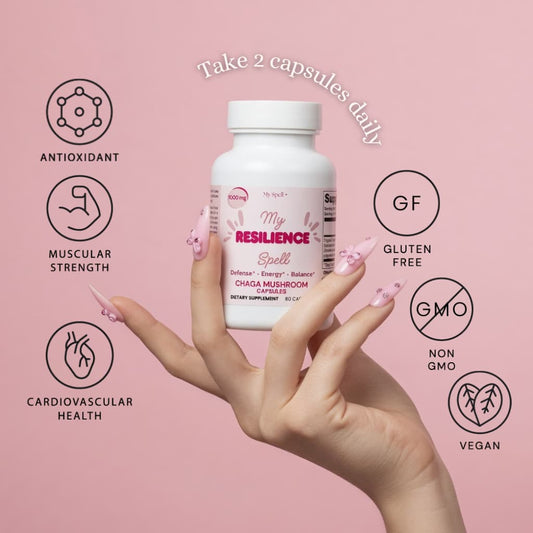 Hand holding a My Spell Supplements Chaga Mushroom supplement bottle labeled 'My Resilience Spell' with health benefits icons on a pink background