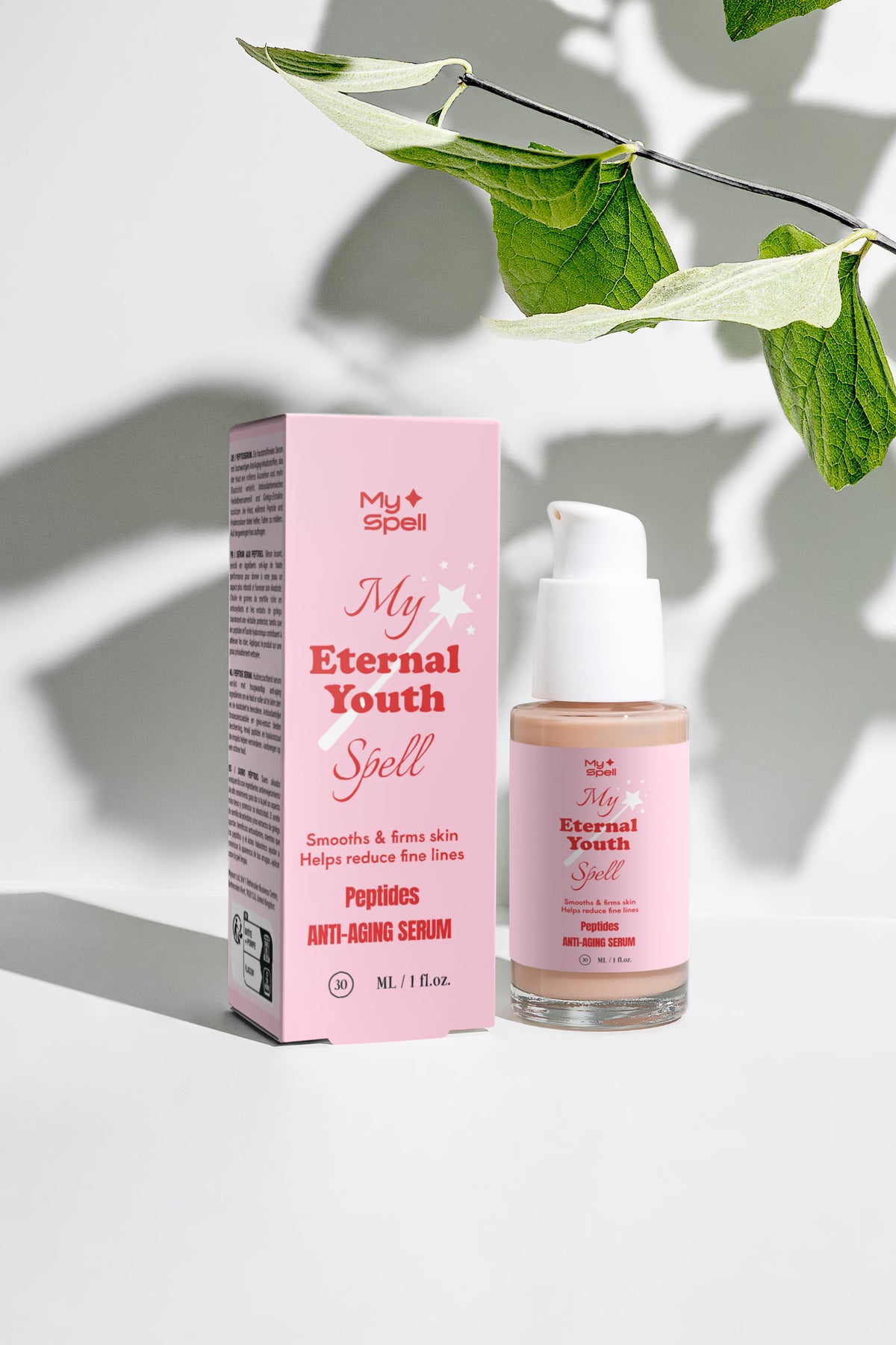 My Spell My Eternal Youth Spell anti-aging serum bottle and its pink packaging box, styled with green leaves on a light gray background with leaf shadows.